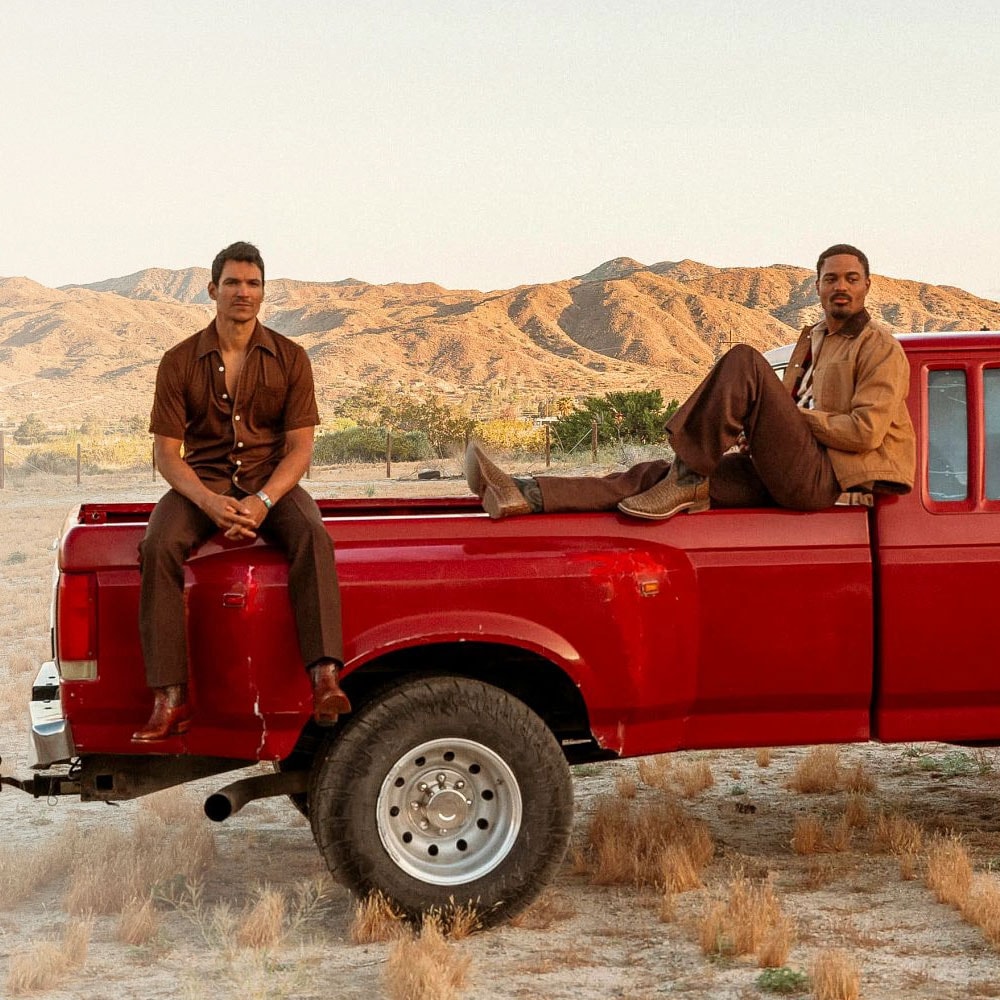 Two men sitting on a truck wearing Signature Series boots and El Paso boots.